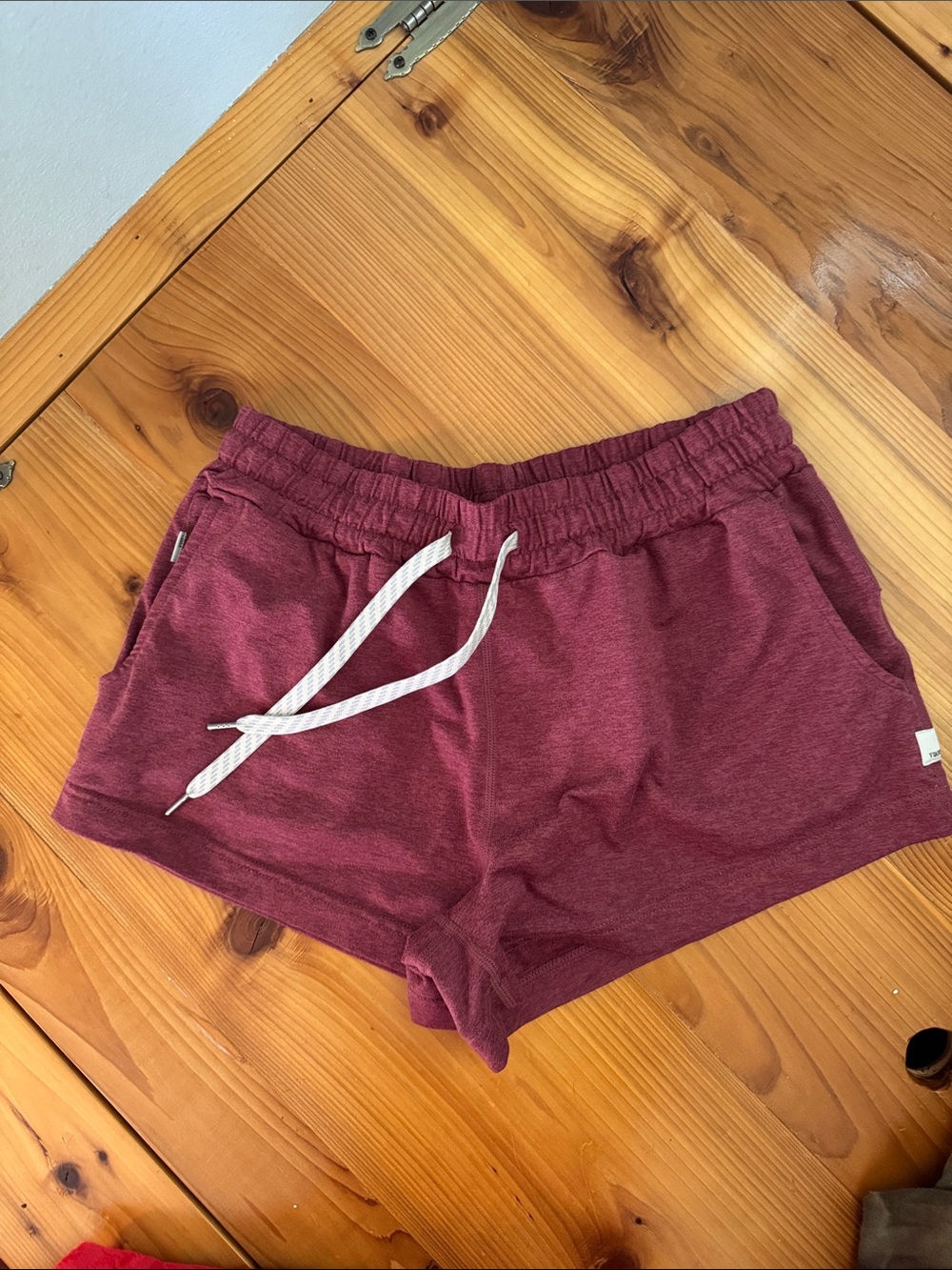 Vuori Halo Drawstring Shorts in maroon heather.